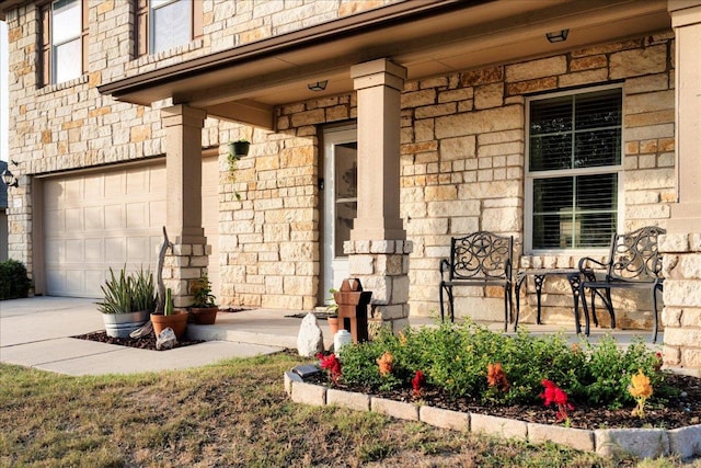 228 Wallops, Kyle, TX 78640 - entrance to property with covered porch, an attached garage, and stone siding