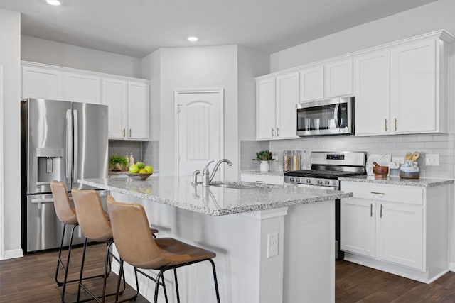 19825 Abigail Fillmore Rd, Manor, TX 78653 - kitchen featuring appliances with stainless steel finishes, white cabinets, recessed lighting, and dark wood-style flooring
