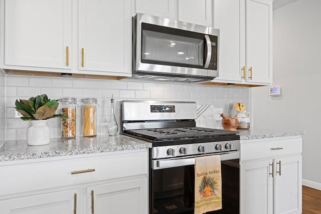 19825 Abigail Fillmore Rd, Manor, TX 78653 - kitchen with stainless steel appliances, decorative backsplash, light stone counters, and white cabinetry