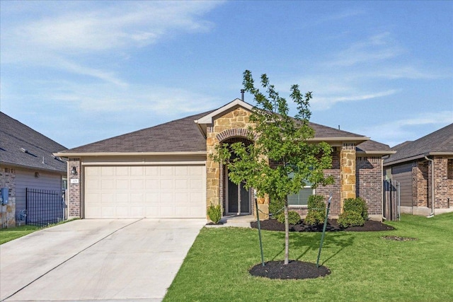 329 Empress Tree Dr, Leander, TX 78641 - view of front of property with an attached garage, concrete driveway, a front lawn, brick siding, and stone siding