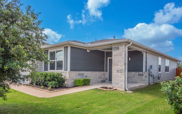 4701 Tully Dr, Pflugerville, TX 78660 - view of home's exterior with a lawn and stone siding