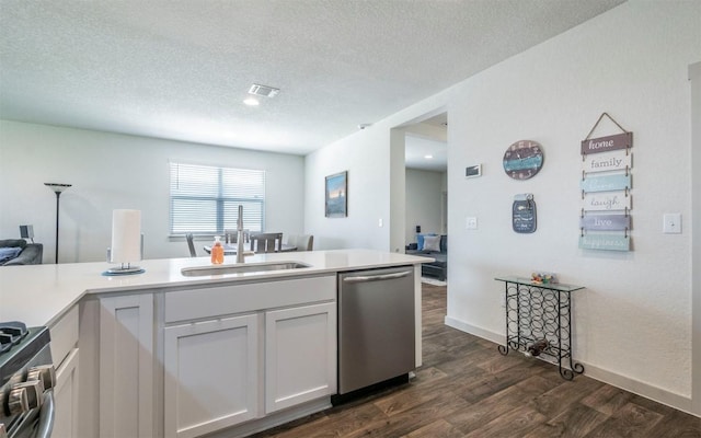 4701 Tully Dr, Pflugerville, TX 78660 - kitchen featuring a sink, stainless steel appliances, dark wood-type flooring, a textured ceiling, and light countertops