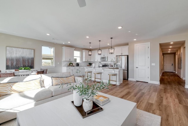 17112 Vernal Rd, Manor, TX 78653 - living area featuring recessed lighting, light wood-style flooring, and baseboards