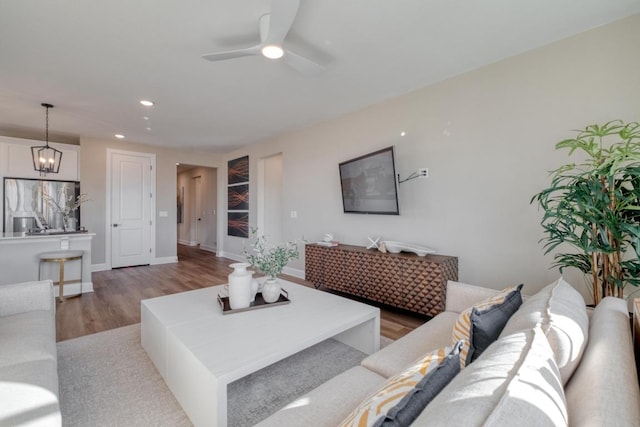 17112 Vernal Rd, Manor, TX 78653 - living area featuring light wood-type flooring, recessed lighting, a chandelier, ceiling fan, and baseboards