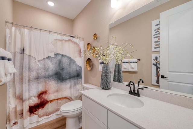 17112 Vernal Rd, Manor, TX 78653 - bathroom featuring vanity, toilet, wood finished floors, and recessed lighting