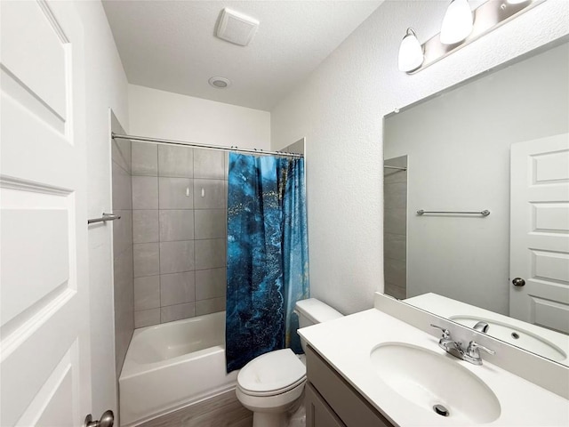 12006 Curlin Cv, Buda, TX 78610 - full bath featuring vanity, toilet, shower / bathtub combination with curtain, and wood finished floors