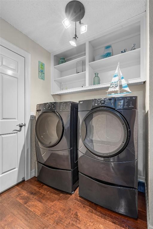 2201 Carolyn Dr, Taylor, TX 76574 - washroom with washer and dryer and wood finished floors