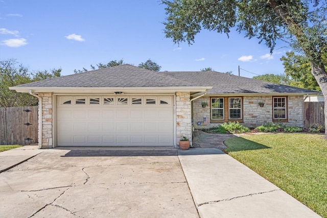 2201 Carolyn Dr, Taylor, TX 76574 - ranch-style home featuring stone siding, driveway, roof with shingles, and an attached garage
