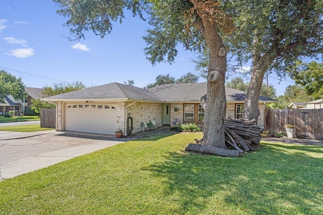 2201 Carolyn Dr, Taylor, TX 76574 - single story home featuring a garage, stone siding, concrete driveway, and a shingled roof