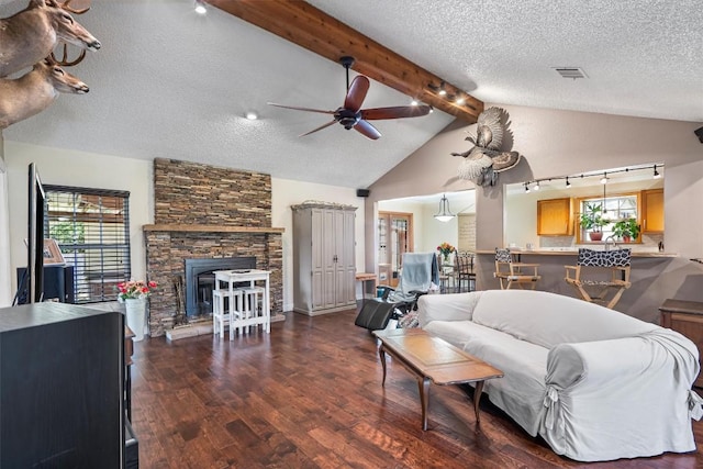 2201 Carolyn Dr, Taylor, TX 76574 - living room with track lighting, a ceiling fan, wood finished floors, plenty of natural light, and a textured ceiling