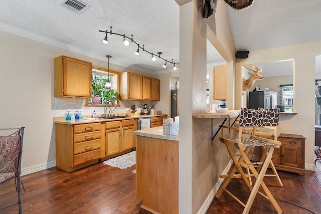 2201 Carolyn Dr, Taylor, TX 76574 - kitchen with a kitchen bar, dark wood-style flooring, backsplash, a textured ceiling, and crown molding