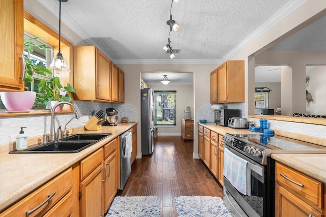 2201 Carolyn Dr, Taylor, TX 76574 - kitchen with appliances with stainless steel finishes, light countertops, a textured ceiling, decorative backsplash, and dark wood finished floors