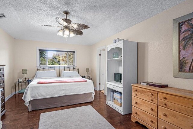 2201 Carolyn Dr, Taylor, TX 76574 - bedroom featuring a textured ceiling, dark wood finished floors, and a ceiling fan