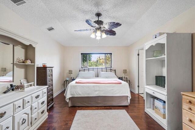 2201 Carolyn Dr, Taylor, TX 76574 - bedroom featuring a textured ceiling, dark wood-style flooring, and ceiling fan