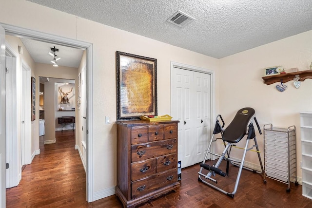 2201 Carolyn Dr, Taylor, TX 76574 - workout area featuring wood finished floors and a textured ceiling