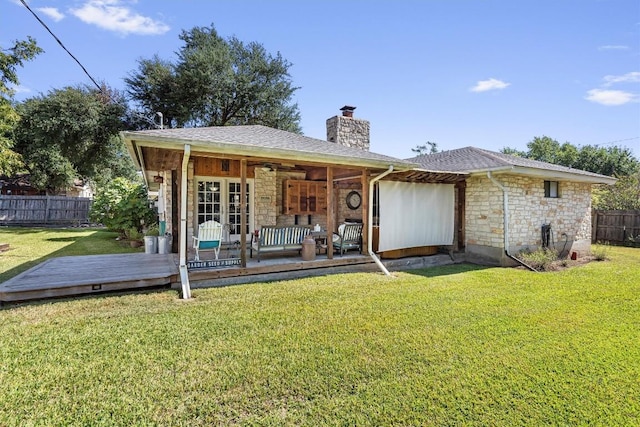 2201 Carolyn Dr, Taylor, TX 76574 - back of property with stone siding, a fenced backyard, a chimney, and a deck