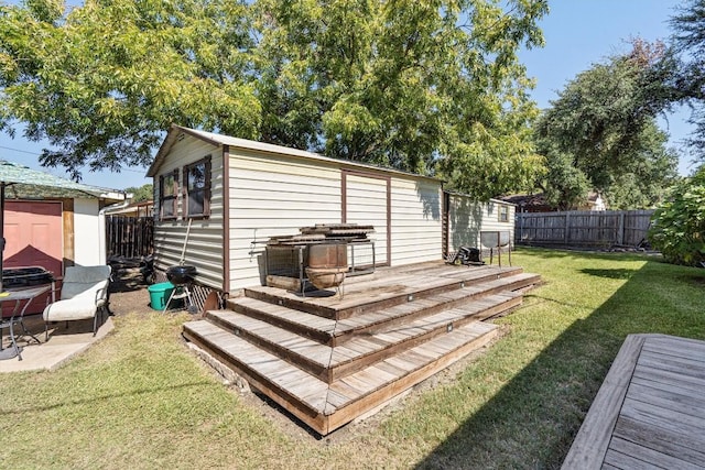 2201 Carolyn Dr, Taylor, TX 76574 - rear view of property with a fenced backyard, a wooden deck, and a shed