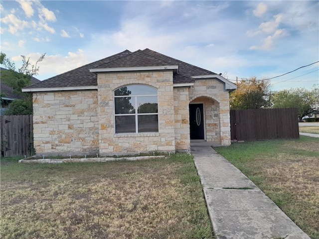 109 E Wheeler St S, Manor, TX 78653 - french provincial home featuring a shingled roof and stone siding