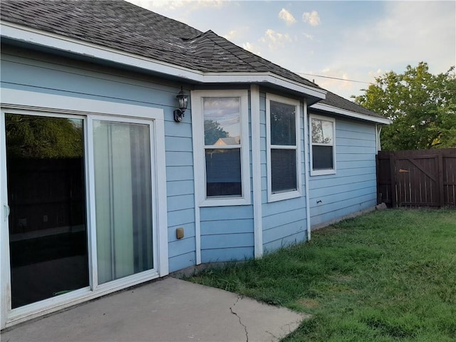 109 E Wheeler St S, Manor, TX 78653 - view of property exterior featuring a shingled roof and a patio area