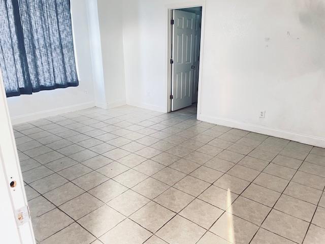 109 E Wheeler St S, Manor, TX 78653 - empty room with light tile patterned floors and baseboards