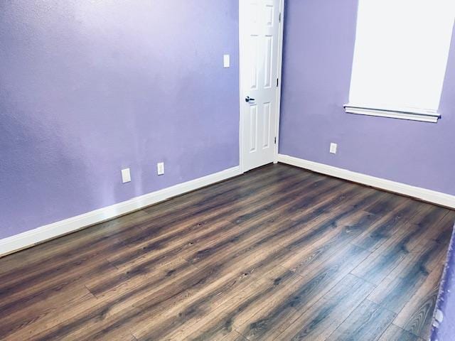 109 E Wheeler St S, Manor, TX 78653 - spare room featuring baseboards and dark wood-style flooring