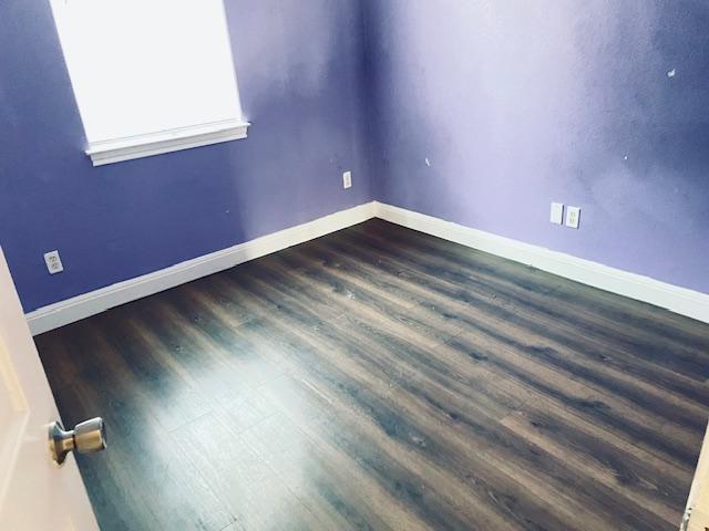 109 E Wheeler St S, Manor, TX 78653 - unfurnished room with dark wood-style floors