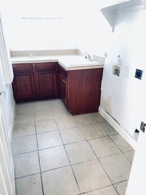 109 E Wheeler St S, Manor, TX 78653 - washroom with hookup for a washing machine, cabinet space, and light tile patterned floors