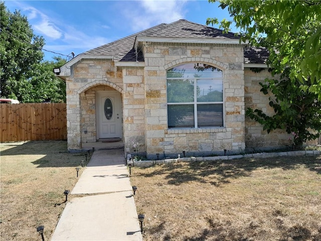 107 E Wheeler St E, Manor, TX 78653 - french country home featuring stone siding and a shingled roof