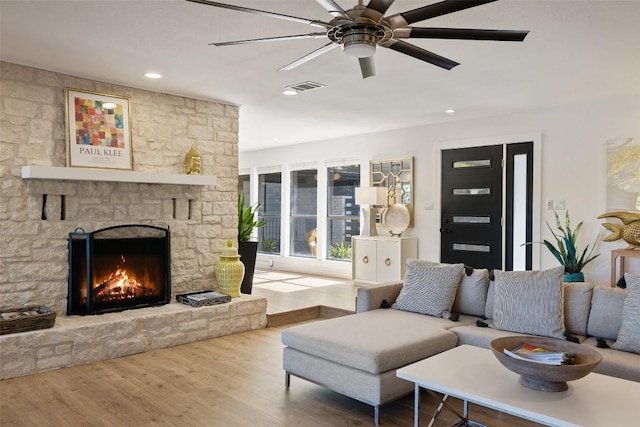 105 Palos Verdes Dr, Lakeway, TX 78734 - living area with a stone fireplace, wood finished floors, a ceiling fan, and recessed lighting