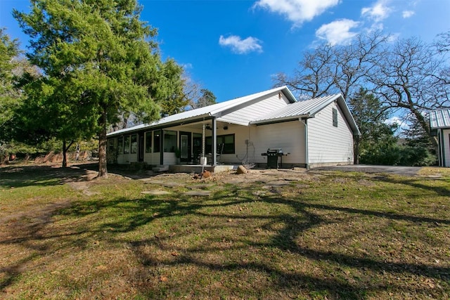 11092 Riley Green Rds Unit 121, Franklin, TX 77856 - back of house with a sunroom, a lawn, and metal roof