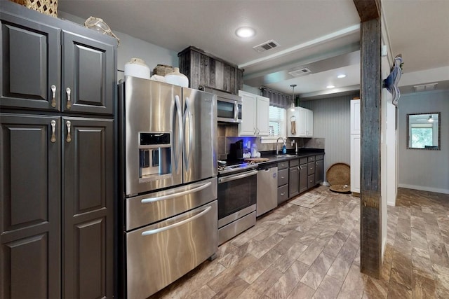 11092 Riley Green Rds Unit 121, Franklin, TX 77856 - kitchen with stainless steel appliances, a sink, dark countertops, pendant lighting, and recessed lighting