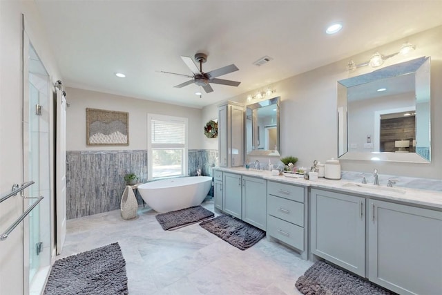 11092 Riley Green Rds Unit 121, Franklin, TX 77856 - bathroom with double vanity, tile walls, a soaking tub, ceiling fan, and a walk in shower