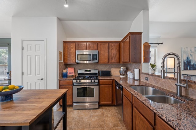 10304 Lone Pine Ln, Austin, TX 78747 - kitchen featuring appliances with stainless steel finishes, a sink, wood counters, and backsplash