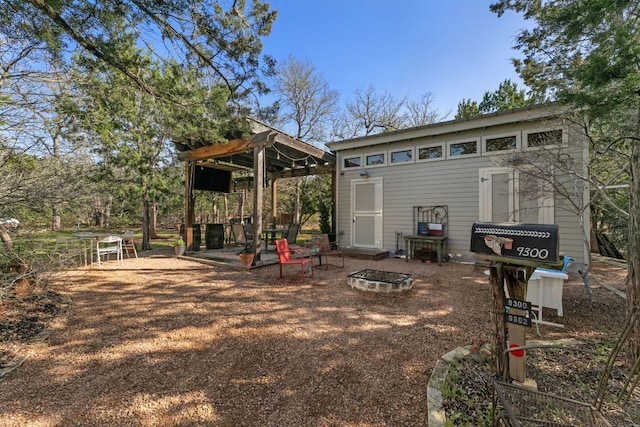 9300 N Madrone Trl, Austin, TX 78737 - back of house with an outdoor fire pit, an outdoor structure, and a patio area