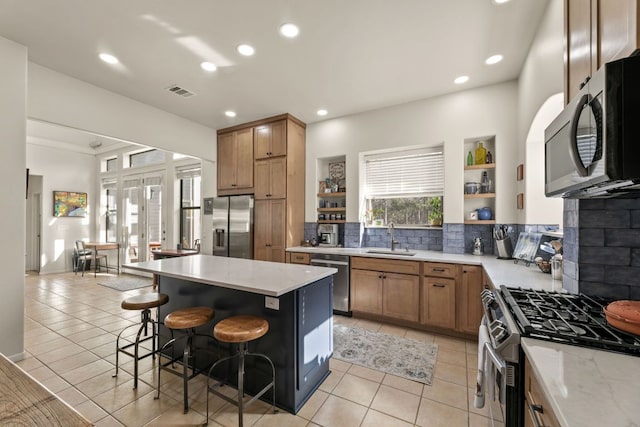 9300 N Madrone Trl, Austin, TX 78737 - kitchen with stainless steel appliances, open shelves, tasteful backsplash, light tile patterned floors, and recessed lighting