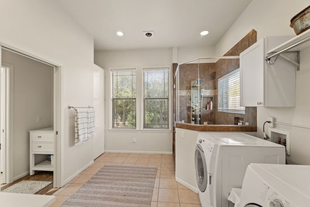 9300 N Madrone Trl, Austin, TX 78737 - laundry area with cabinet space, washing machine and clothes dryer, light tile patterned floors, and recessed lighting