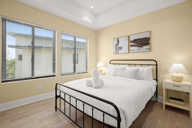 1405 Parkinson Dr, Austin, TX 78704 - bedroom featuring wood finished floors, baseboards, recessed lighting, and a tray ceiling