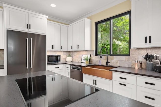 1405 Parkinson Dr, Austin, TX 78704 - kitchen featuring stainless steel appliances, a sink, tasteful backsplash, white cabinets, and recessed lighting