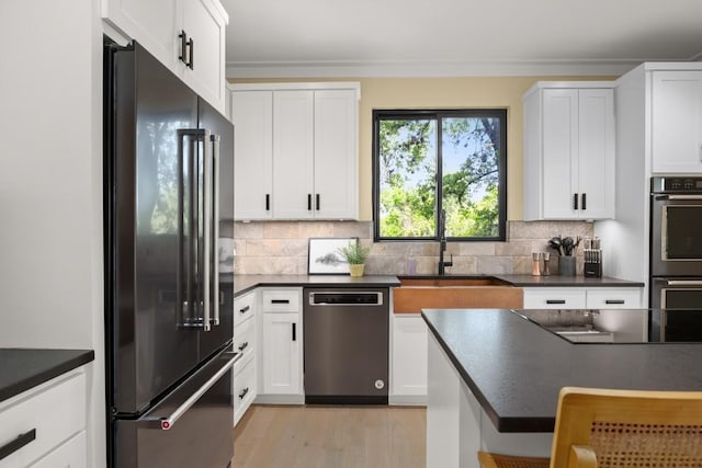 1405 Parkinson Dr, Austin, TX 78704 - kitchen with high end fridge, stainless steel dishwasher, black electric cooktop, a sink, and dark countertops