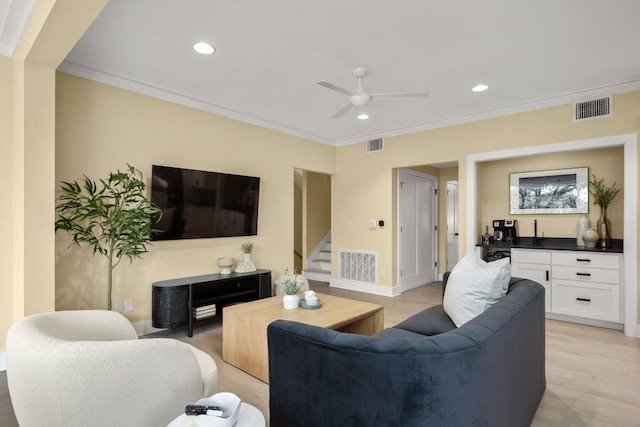 1405 Parkinson Dr, Austin, TX 78704 - living area featuring stairway, crown molding, light wood-style floors, a ceiling fan, and recessed lighting