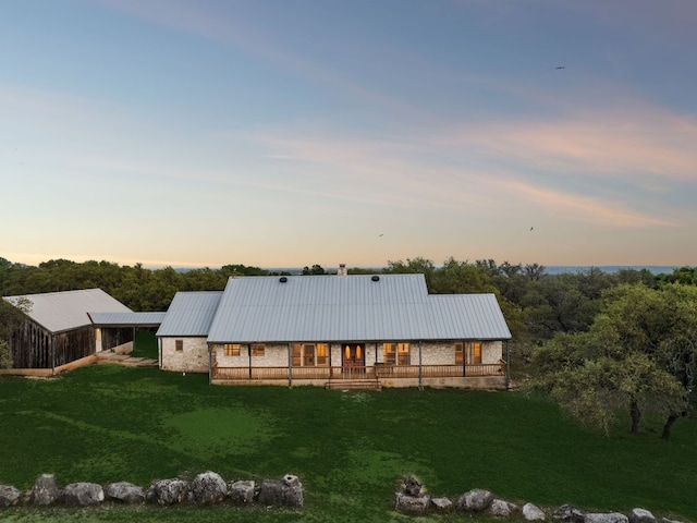 27846 Natural Bridge Caverns Rd, San Antonio, TX 78266 - back of property with a lawn, metal roof, and covered porch
