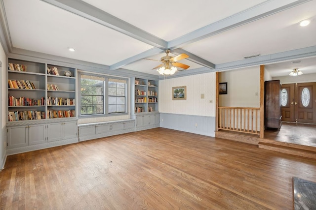 27846 Natural Bridge Caverns Rd, San Antonio, TX 78266 - unfurnished living room with wood finished floors, healthy amount of natural light, ceiling fan, beamed ceiling, and a wainscoted wall