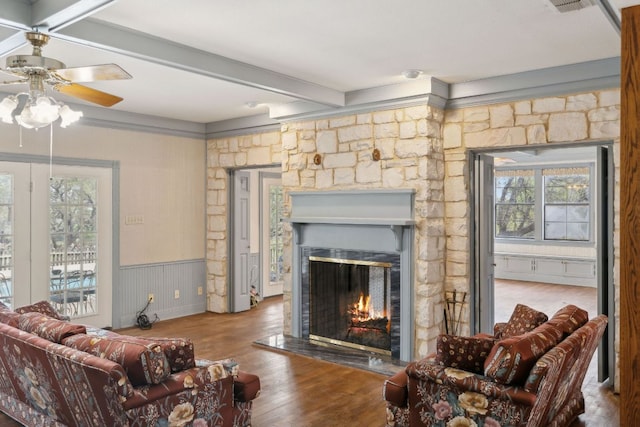 27846 Natural Bridge Caverns Rd, San Antonio, TX 78266 - living area with a warm lit fireplace, plenty of natural light, wood finished floors, ceiling fan, and beamed ceiling