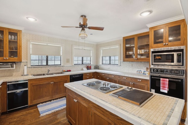 27846 Natural Bridge Caverns Rd, San Antonio, TX 78266 - kitchen featuring black appliances, brown cabinetry, a sink, tasteful backsplash, and dark wood-type flooring
