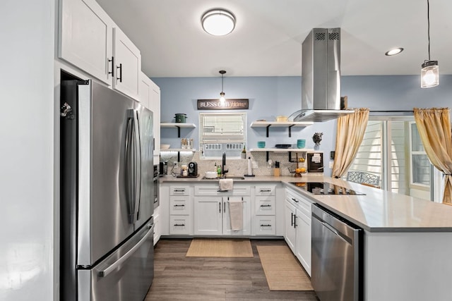 810 Monterrey St, Lockhart, TX 78644 - kitchen with appliances with stainless steel finishes, open shelves, island range hood, a sink, and a peninsula