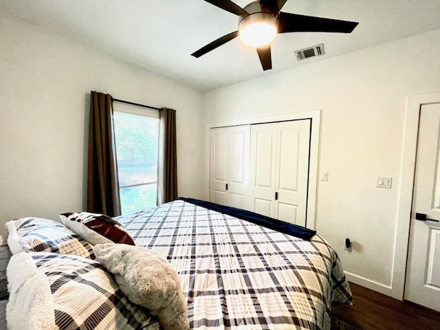810 Monterrey St, Lockhart, TX 78644 - bedroom featuring dark wood-style floors, baseboards, a closet, and ceiling fan