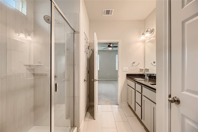 2009 Jacey Way, Austin, TX 78725 - bathroom with ceiling fan, vanity, a stall shower, tile patterned flooring, and healthy amount of natural light