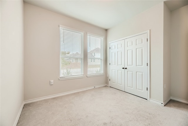 2009 Jacey Way, Austin, TX 78725 - unfurnished bedroom featuring multiple windows, light carpet, and baseboards