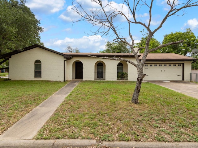 220 E Belton Ave, Rockdale, TX 76567 - view of front of home with an attached garage, driveway, a front yard, and brick siding