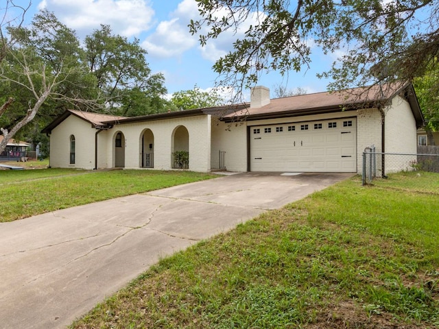 220 E Belton Ave, Rockdale, TX 76567 - view of front of house featuring driveway, a chimney, an attached garage, and brick siding